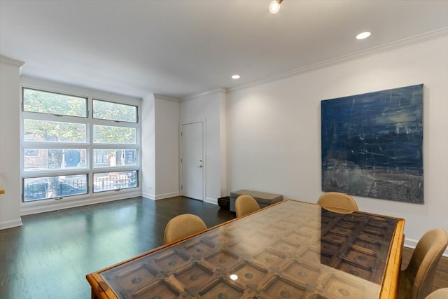 dining room with dark hardwood / wood-style flooring and crown molding