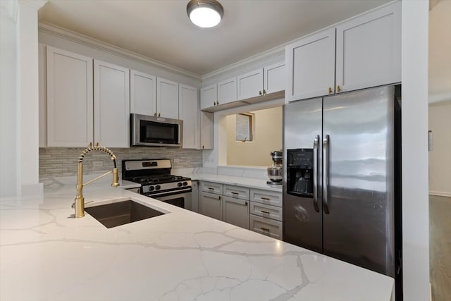 kitchen with ornamental molding, tasteful backsplash, stainless steel appliances, light stone counters, and sink