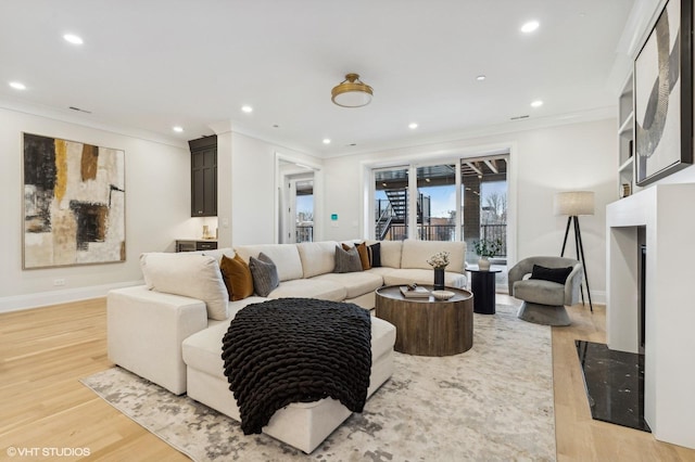 living room with hardwood / wood-style floors and crown molding