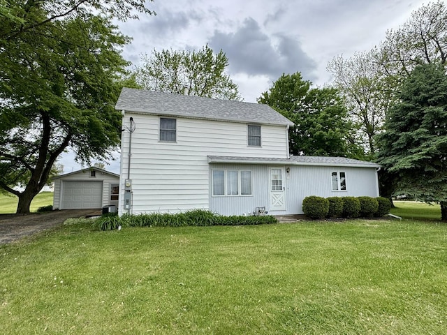 321 E N St, Sheffield, IL 61361 - back of house with an outbuilding, driveway, a lawn, and a detached garage