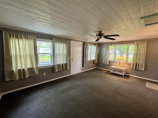 321 E N St, Sheffield, IL 61361 - spare room featuring dark carpet, baseboards, wood ceiling, and a ceiling fan