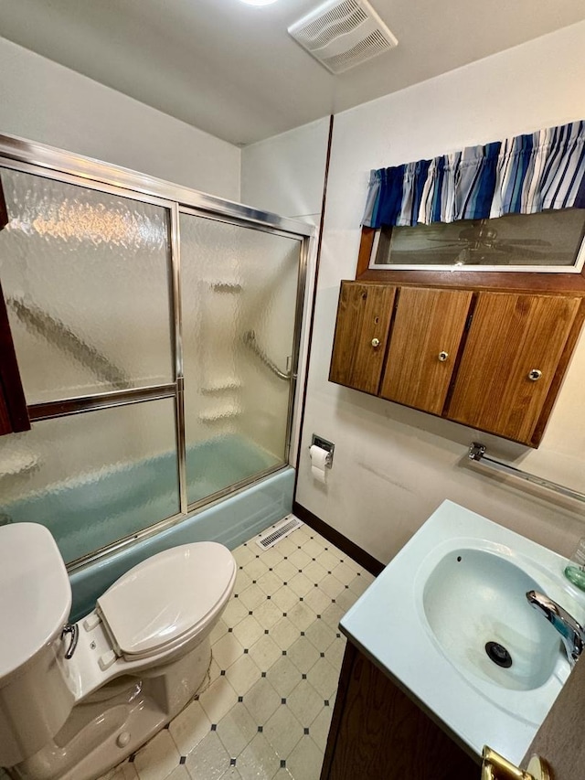 321 E N St, Sheffield, IL 61361 - bathroom featuring toilet, bath / shower combo with glass door, tile patterned floors, baseboards, and vanity