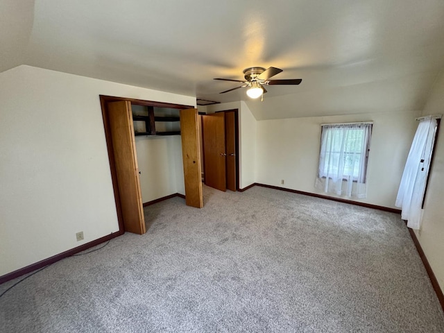 321 E N St, Sheffield, IL 61361 - unfurnished bedroom featuring carpet, vaulted ceiling, baseboards, and multiple closets