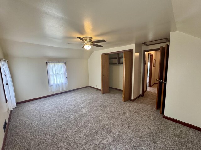 321 E N St, Sheffield, IL 61361 - unfurnished bedroom with light carpet, a closet, ceiling fan, vaulted ceiling, and baseboards