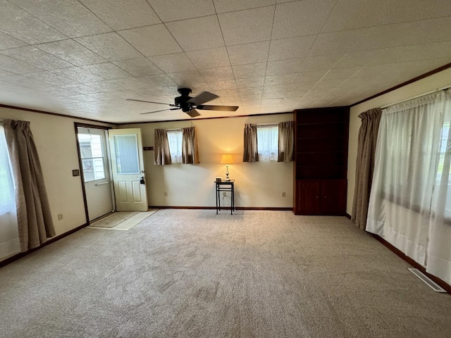321 E N St, Sheffield, IL 61361 - carpeted empty room featuring baseboards, a ceiling fan, and crown molding