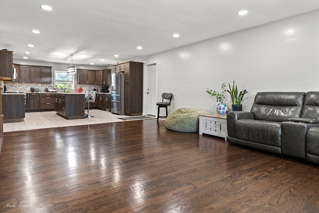 unfurnished living room with dark wood-type flooring