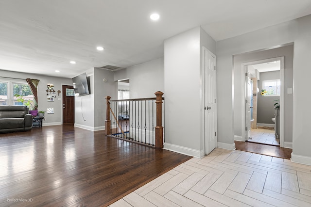 kitchen with light stone countertops, decorative backsplash, decorative light fixtures, and a breakfast bar area