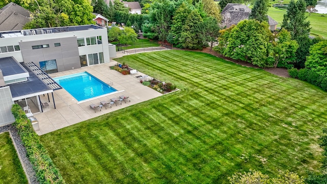 view of swimming pool featuring a yard and a patio area