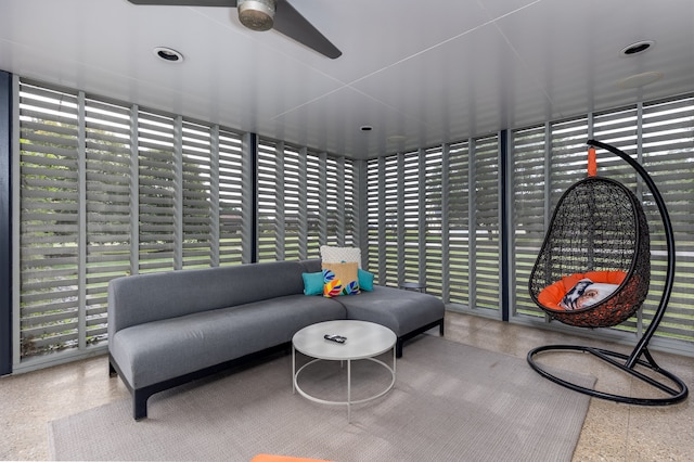 sunroom / solarium featuring ceiling fan