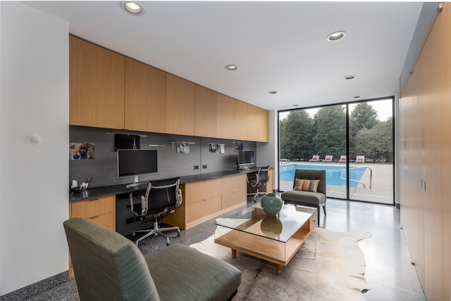 office space with floor to ceiling windows and built in desk