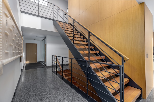 stairs featuring a high ceiling