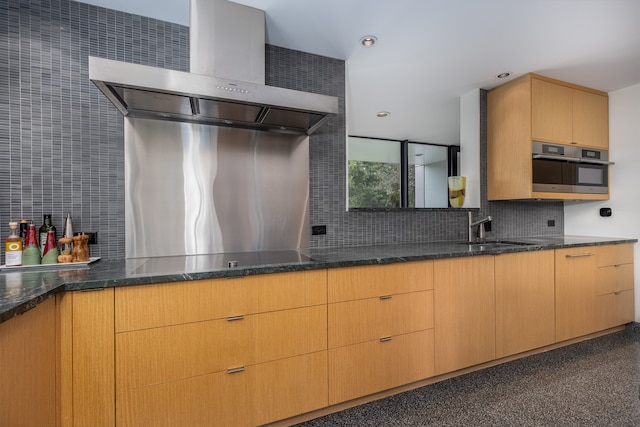 kitchen with dark stone counters, sink, wall chimney range hood, black electric cooktop, and stainless steel oven