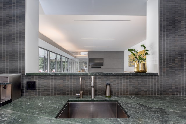 kitchen with tile walls and sink