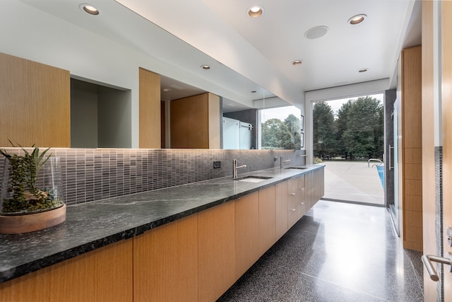 bathroom featuring vanity and tasteful backsplash