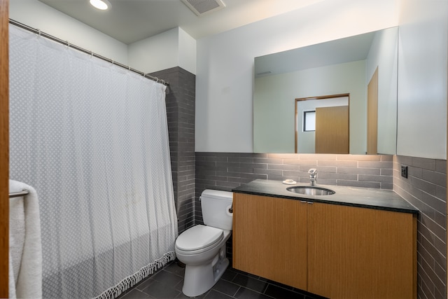 bathroom featuring tile walls, tile patterned flooring, a shower with shower curtain, vanity, and toilet