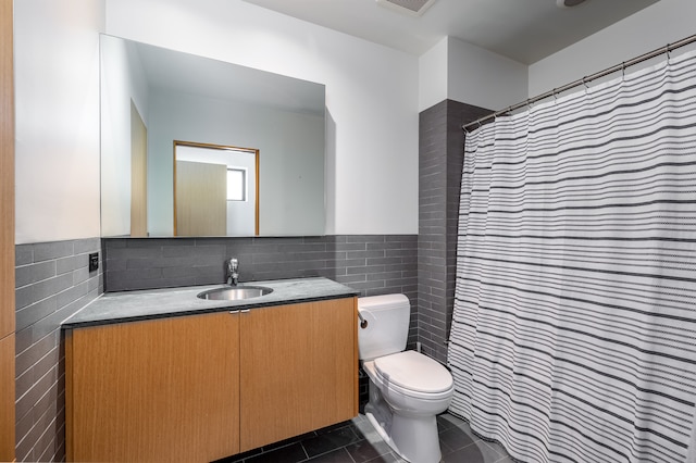 bathroom featuring vanity, tile walls, toilet, and tile patterned floors