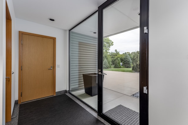 doorway featuring light carpet