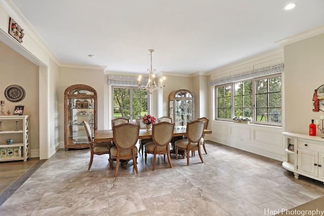 dining space featuring crown molding and a notable chandelier