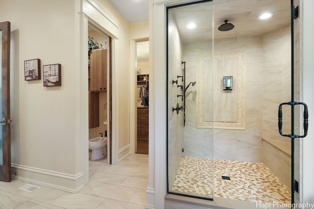 bathroom with a bidet, a shower with door, and tile patterned flooring