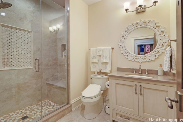 bathroom with tile patterned floors, toilet, an enclosed shower, and vanity