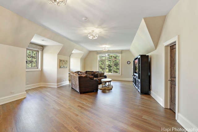 interior space with lofted ceiling, wood-type flooring, and plenty of natural light