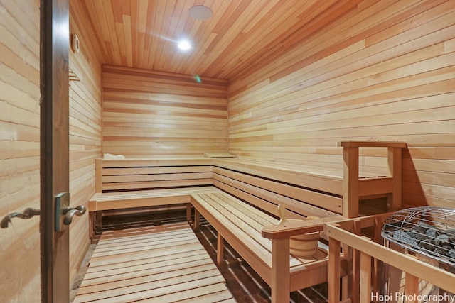 view of sauna featuring hardwood / wood-style flooring, wooden walls, and wooden ceiling