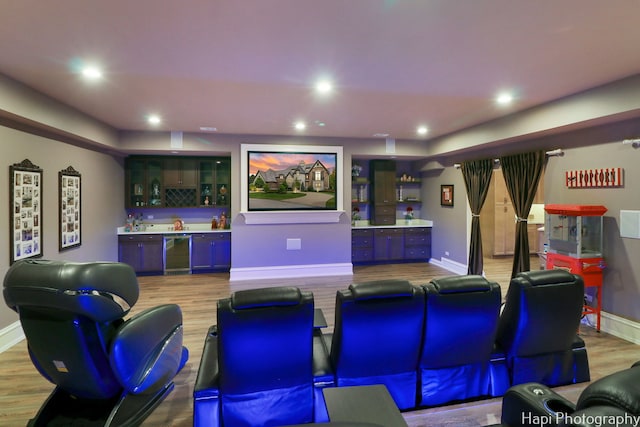 home theater room with hardwood / wood-style flooring, wine cooler, and indoor bar