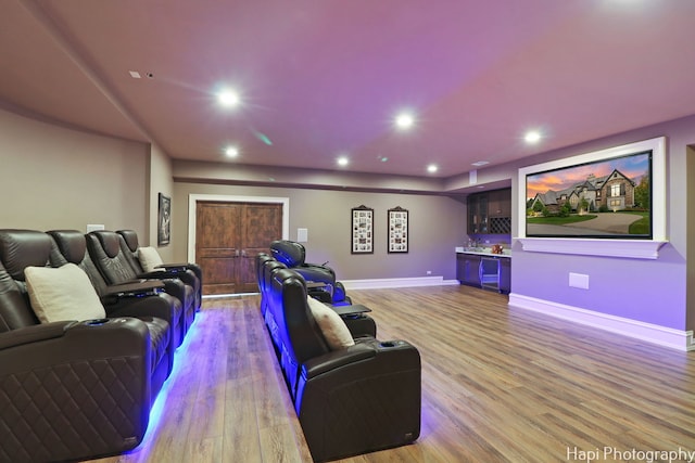 home theater room with light hardwood / wood-style floors