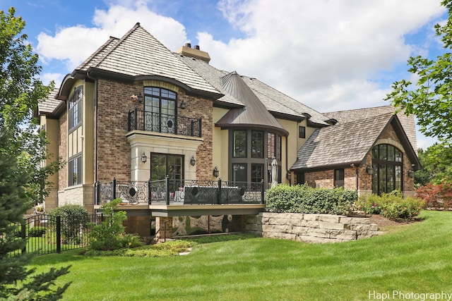 back of house featuring a yard and a wooden deck