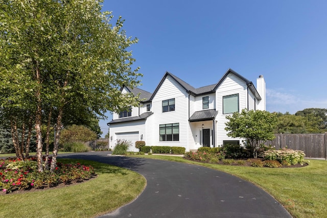 view of front of house with a front yard and a garage