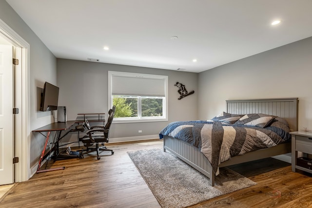 bedroom with hardwood / wood-style flooring