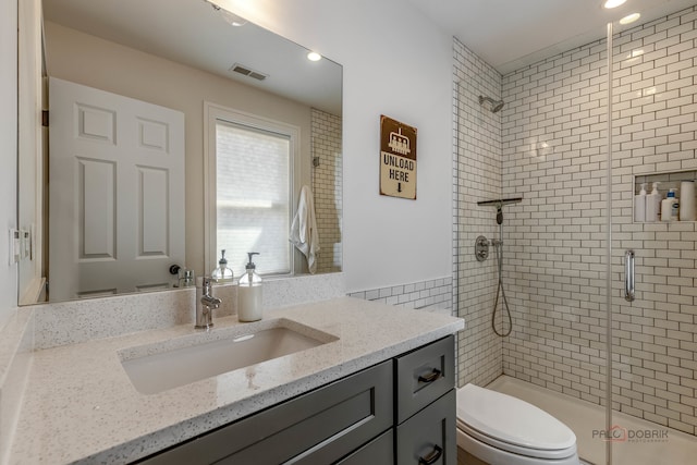 bathroom with vanity, toilet, and walk in shower