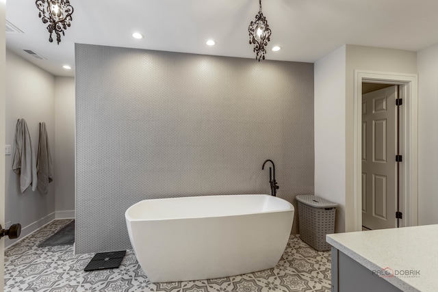 bathroom featuring tile patterned flooring, vanity, and a bathing tub