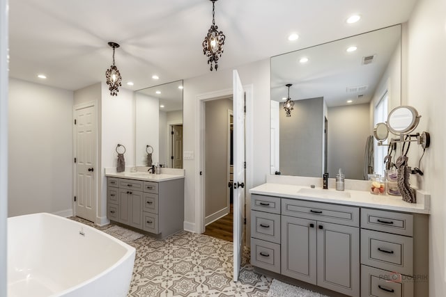 bathroom featuring a bathing tub, vanity, and wood-type flooring