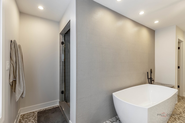 bathroom featuring tile patterned floors and separate shower and tub