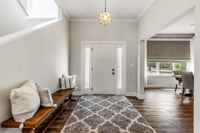 entrance foyer with dark hardwood / wood-style floors and ornamental molding