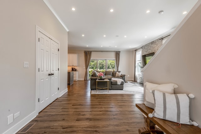 living room with dark hardwood / wood-style floors and ornamental molding