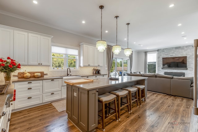 kitchen with white cabinets, a center island, and a wealth of natural light