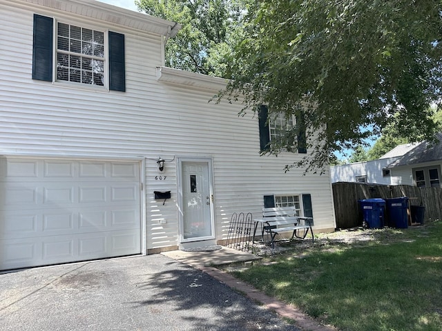 view of front of house with a garage and fence