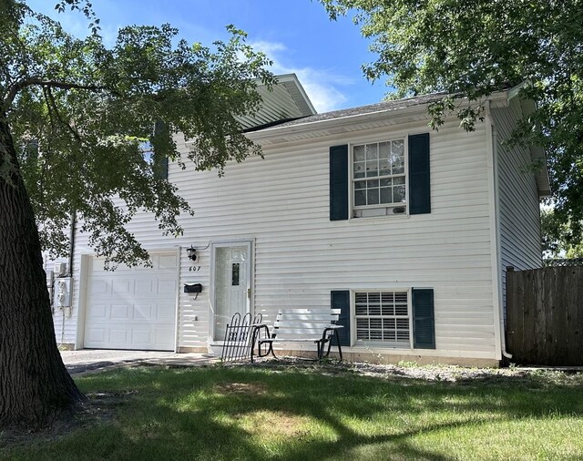 exterior space featuring a garage and a front yard