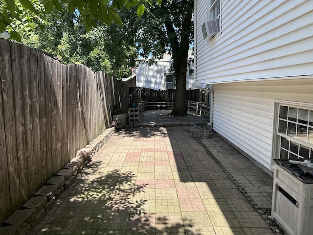 view of patio with cooling unit and a fenced backyard