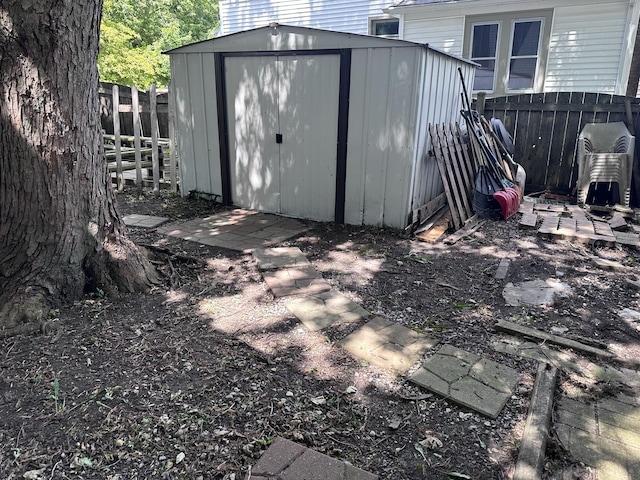 view of shed featuring fence