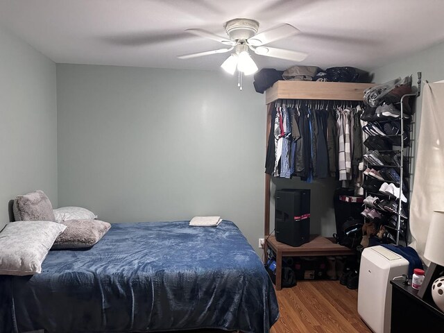 bedroom featuring hardwood / wood-style floors and ceiling fan