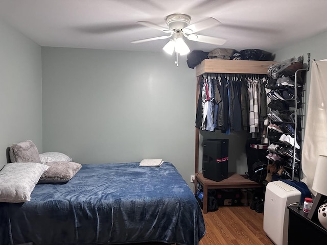 bedroom featuring ceiling fan and wood finished floors