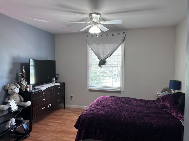 bedroom with ceiling fan and light hardwood / wood-style floors