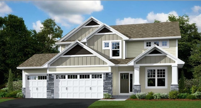 craftsman inspired home featuring a front yard and a garage