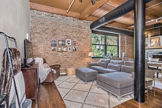 living room with wood ceiling, wood-type flooring, and brick wall