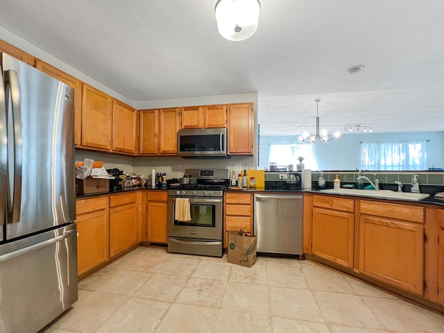 kitchen featuring stainless steel appliances, an inviting chandelier, sink, hanging light fixtures, and light tile patterned flooring