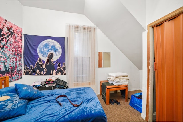 bedroom featuring lofted ceiling and carpet floors