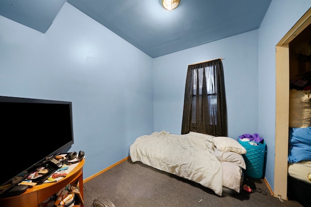 carpeted bedroom with lofted ceiling